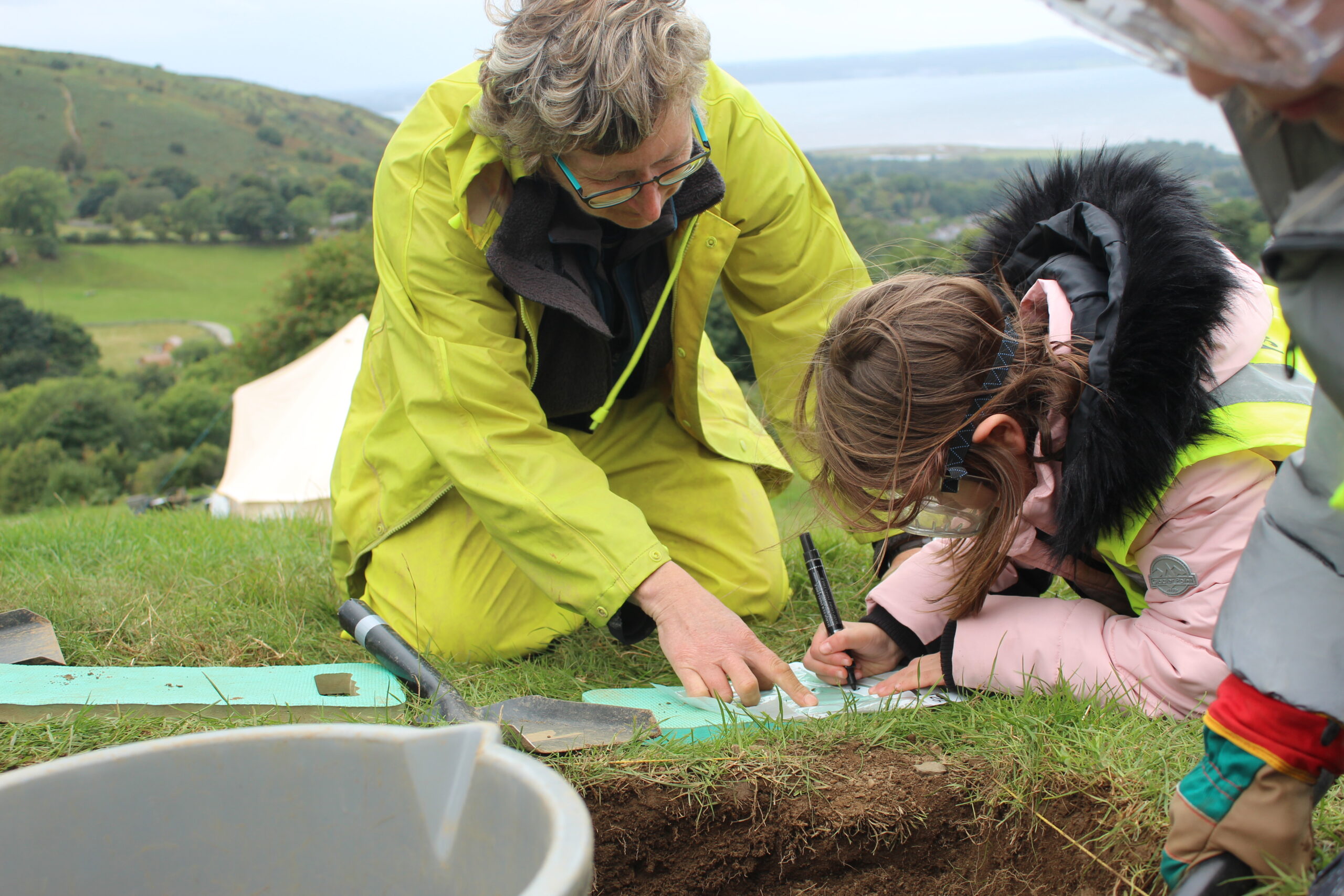 Neolithic Axes - test pit excavation with local school children and Senior Archaeologist Jane Kenny from Gwynedd Archaeological Trust